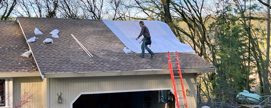 Tarping a roof to prevent water damage