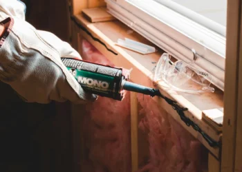 Applying sealant for a new window installation photo by Erik McClean, Pexels