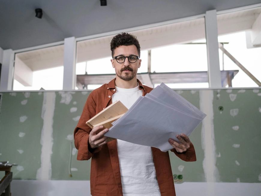 Man holding papers and documents photo by cottonbro studio / Pexels