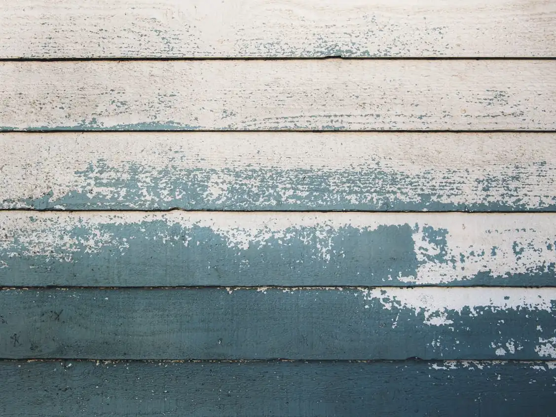 Paint peeling from house siding, photo by Tim Mossholder / Pexels